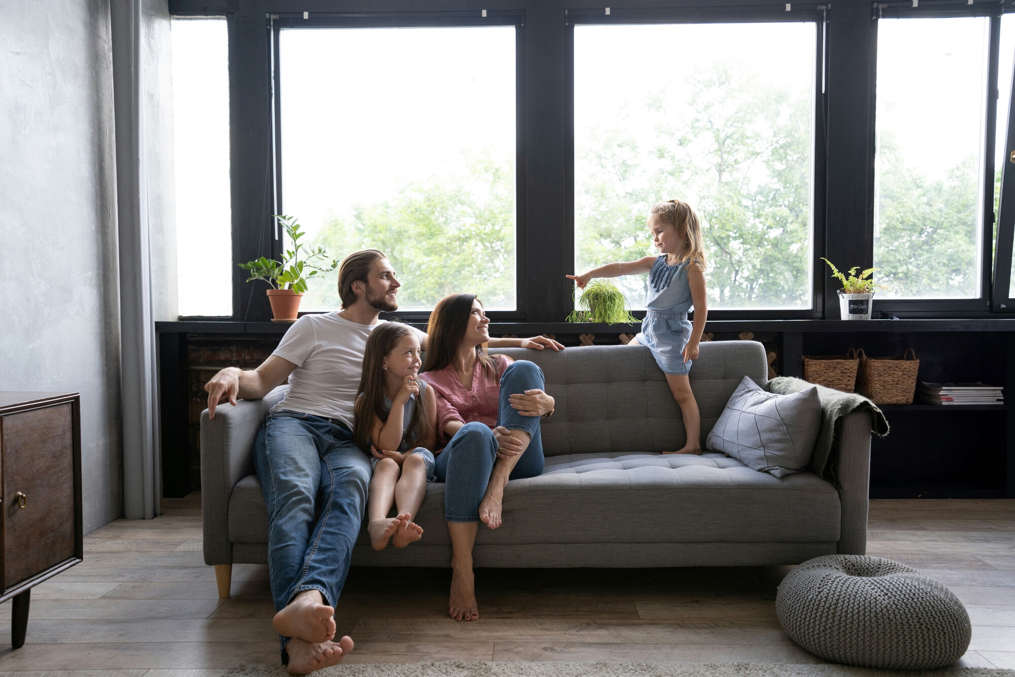 A family relaxed on their sofa, together with relatives in their Higlo shared space on the TV